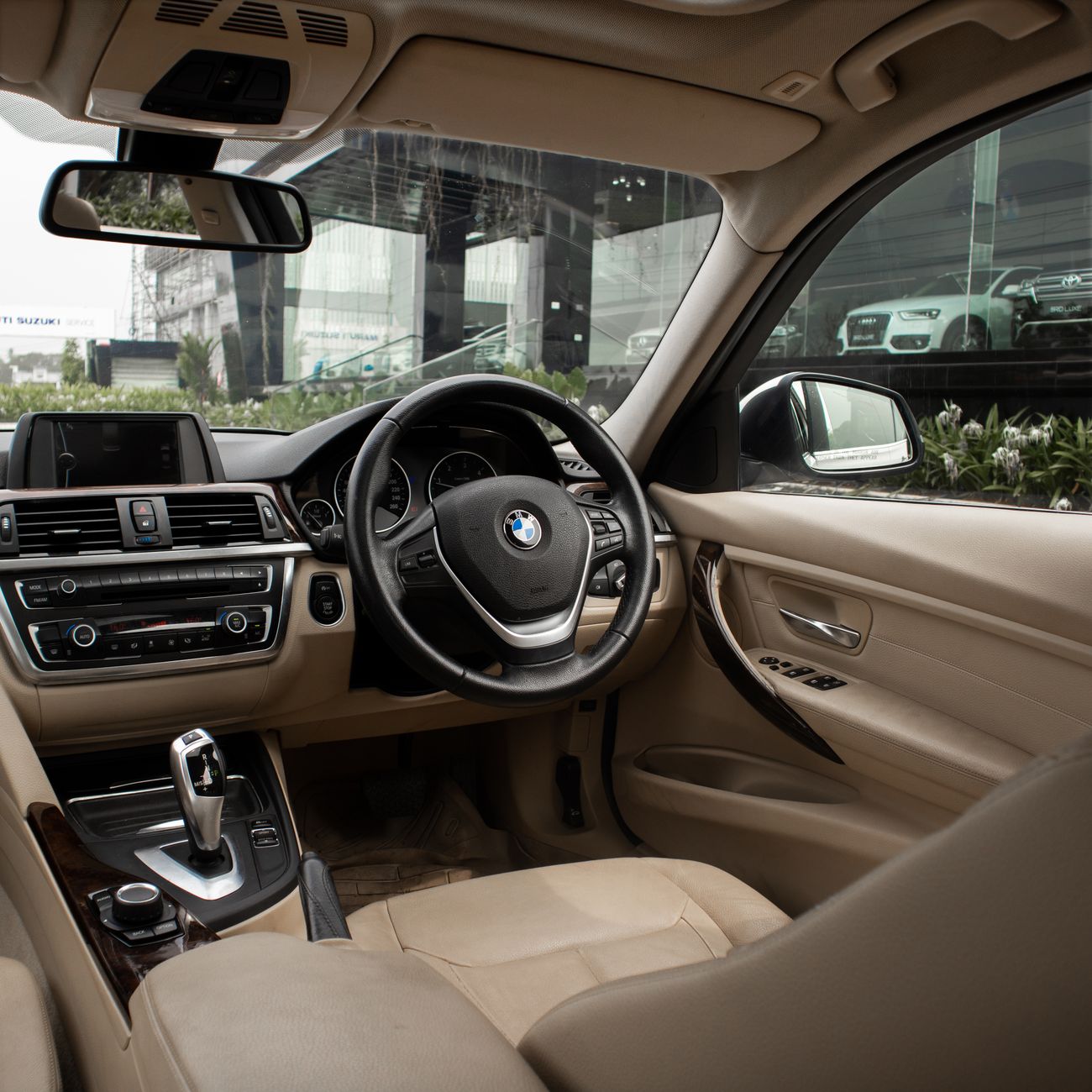 Car interior being carefully cleaned with a detailing brush